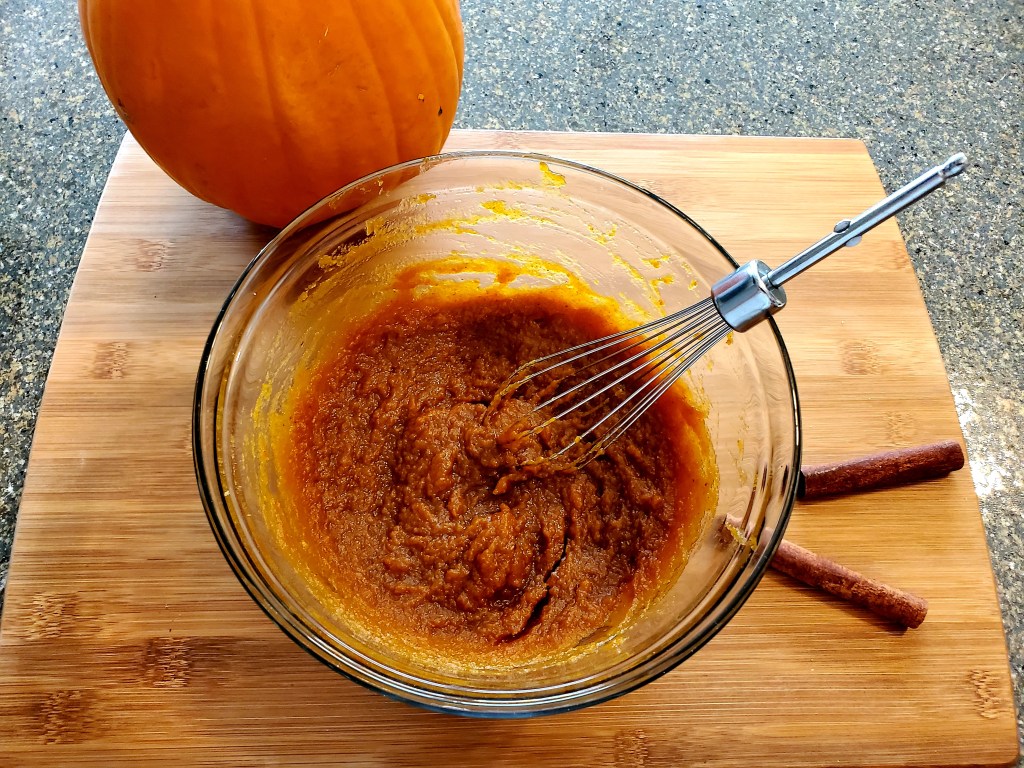 Pumpkin and brown sugar mixed in bowl